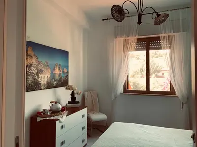 a bedroom with a bed and a window and a dresser at Appartamento Citreum in Balestrate