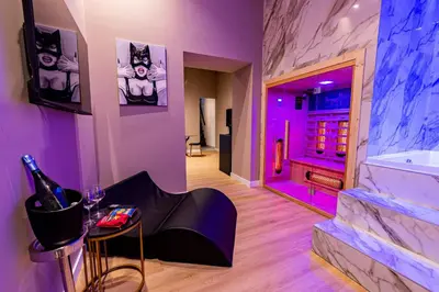 a room with a tub and a table with a bottle of wine at GM Luxury Apartment in Palermo