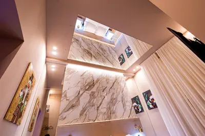 a large marble wall in a room with a curtain at GM Luxury Apartment in Palermo