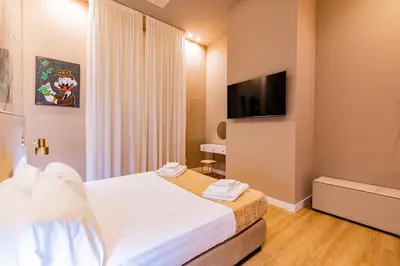 a hotel room with a bed and a flat screen tv at GM Luxury Apartment in Palermo