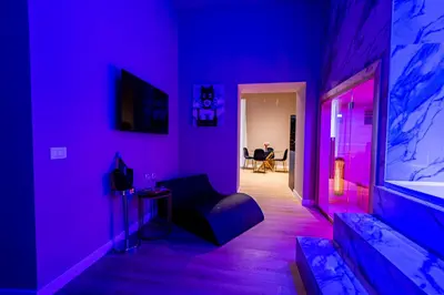 a purple room with a couch and a table at GM Luxury Apartment in Palermo