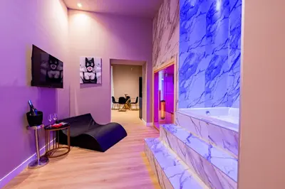 a purple bathroom with a tub and a table at GM Luxury Apartment in Palermo