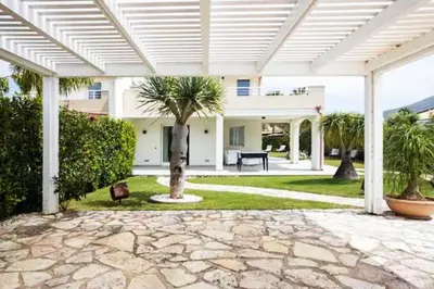 an outdoor patio with a white pergola at Luxury Hot tub Swimming pool Private pool Wi-Fi BBQ in Castellammare del Golfo