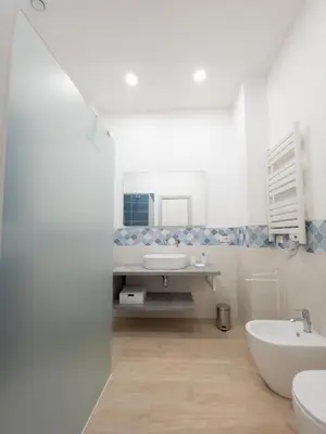 a bathroom with a sink and a toilet and a tub at Light Charme, Sea Light Apartment a due passi dalla PIAZZA DUOMO in Terrasini