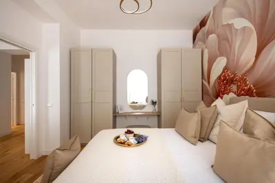 a bedroom with a bed with a plate of food on it at Lo Jacono Apartments by Wonderful Italy in Palermo