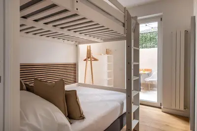 a bedroom with a bed with a painting on the wall at Lo Jacono Apartments by Wonderful Italy in Palermo