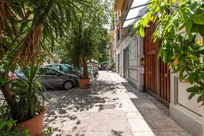 a hallway with white walls and potted plants at Lo Jacono Apartments by Wonderful Italy in Palermo