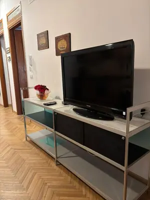 a flat screen tv sitting on a entertainment center at House La Cantinetta in Palermo