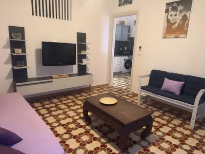 a living room with a couch and a coffee table at Emma's Beach Apartment in Isola delle Femmine