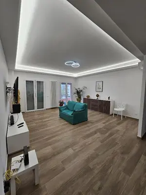 a living room with a green couch and wooden floors at Palermo Francia in Palermo