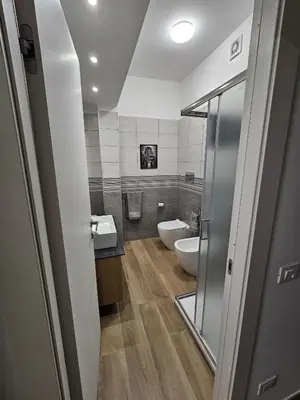 a bathroom with a toilet and a sink and a mirror at Palermo Francia in Palermo