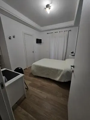 a bedroom with a bed and a sink in a room at Palermo Francia in Palermo