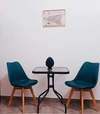two chairs and a table with a potted plant on it at Diana ai Quattro Canti - centro storico Palermo in Palermo