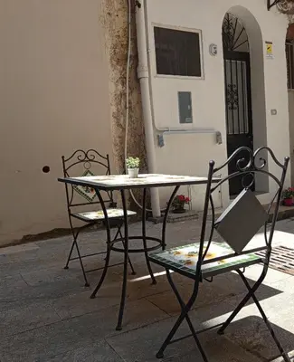 a table and two chairs in front of a building at Diana ai Quattro Canti - centro storico Palermo in Palermo