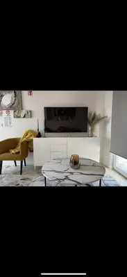 a living room with a table and a tv at Dagma Spa Home Sicilia in Carini