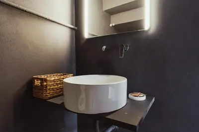 a bathroom with a white sink and a mirror at Cattedrale Suite in Palermo