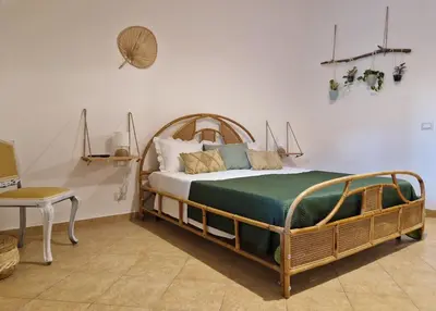 a bedroom with a bed and a chair and a table at Love nest cathedral ,in the heart of the city in Palermo