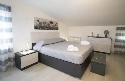 a bedroom with a bed with two towels on it at Villa degli Ulivi in Partinico