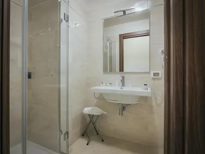a bathroom with a sink and a glass shower at Hotel Costa Azul in Balestrate