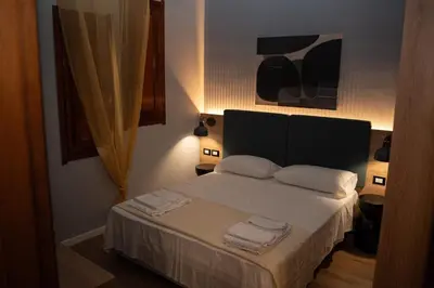a bedroom with a bed with two towels on it at Aurooms in Cinisi