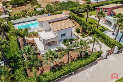 an aerial view of a house with a swimming pool and palm trees at Villa with private Pool in Castellammare dei Golfo in Castellammare del Golfo