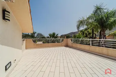a balcony of a house with palm trees at Villa with private Pool in Castellammare dei Golfo in Castellammare del Golfo