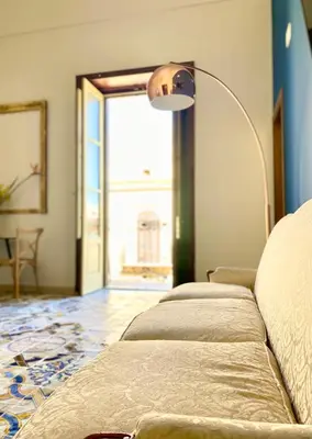 a row of beds in a room with a lamp at Palazzo 700 in Castellammare del Golfo