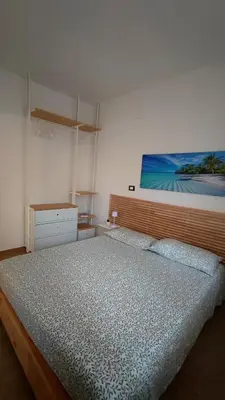a bedroom with a bed and a painting on the wall at Heaven House Sicily in Carini
