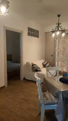 a living room with a couch and a table at Heaven House Sicily in Carini
