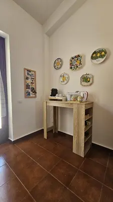 a room with a table and plates on the wall at Villa del Faro, Capo Zafferano in Santa Flavia