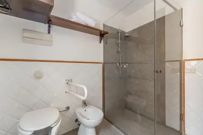 a bathroom with a toilet and a shower at GuestHost - Central Apartment Palermo in Palermo