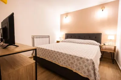 a bedroom with a bed and a flat screen tv at Flat in center 2 in Palermo