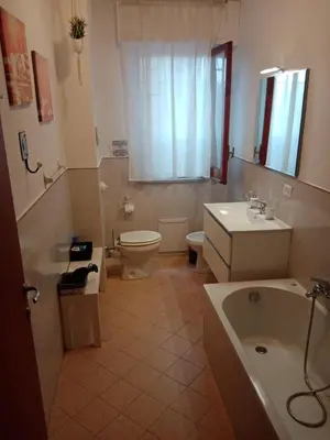 a bathroom with a toilet and a sink and a tub at Dante091 in Palermo