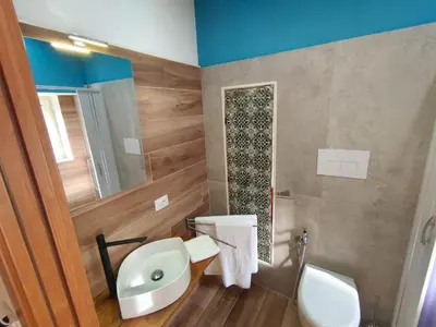 a bathroom with a sink and a toilet and a mirror at Atypical Rooms in Palermo