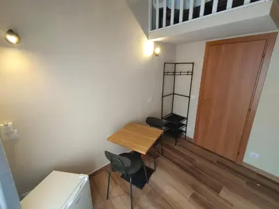 a small room with a wooden table and chairs at Atypical Rooms in Palermo