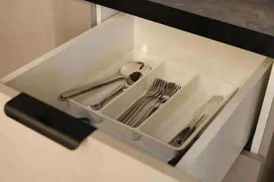 a white drawer with silver utensils in it at VFH Blue Breeze holiday home in Porticello