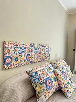 two pillows sitting on top of a bed with a wall at La Casa del Sole in Corleone