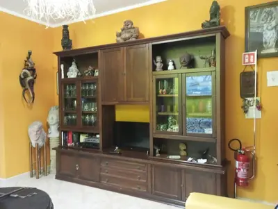 a large wooden entertainment center in a living room at Mami house in Sambuca di Sicilia