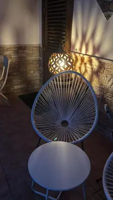 a white table and a white table and a chair at da Mimì in San Vito lo Capo