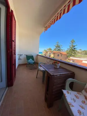 a balcony with a table and a view of the ocean at Casa Bluet on the Sea in Balestrate
