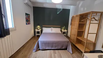 a bedroom with a bed and two side tables at Sichilia House in Palermo