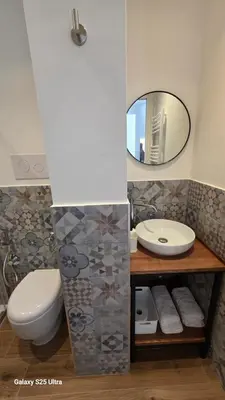 a bathroom with a toilet and a sink and a mirror at Sichilia House in Palermo