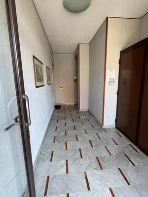 an empty hallway with a tile floor and a door at Castelforte House in Palermo