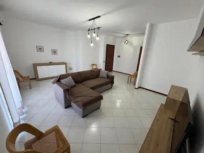a living room with a couch and a table at Castelforte House in Palermo