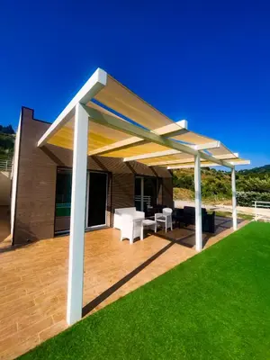 a pavilion on a deck with a green lawn at The Villa - Lascari Cefalu' in Lascari