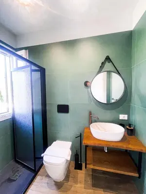 a bathroom with a sink and a toilet and a mirror at The Villa - Lascari Cefalu' in Lascari