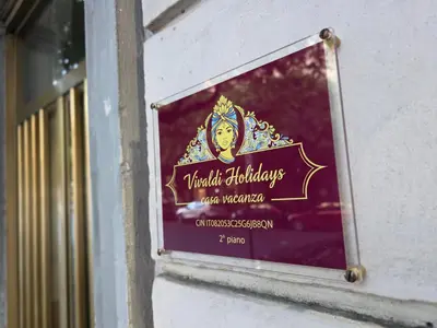 a sign on the side of a building at Vivaldi Holidays Historic house in the center of Palermo in Palermo