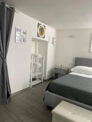a bedroom with a bed and a shelf at La casetta dei Mori in Palermo