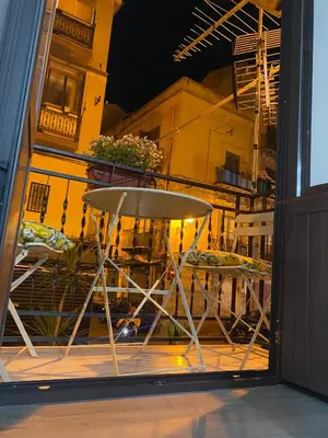 a table and chairs sitting outside of a window at La casetta dei Mori in Palermo
