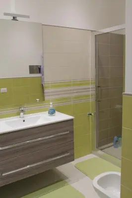 a bathroom with a sink and a shower at Casa Totino Mondello in Palermo